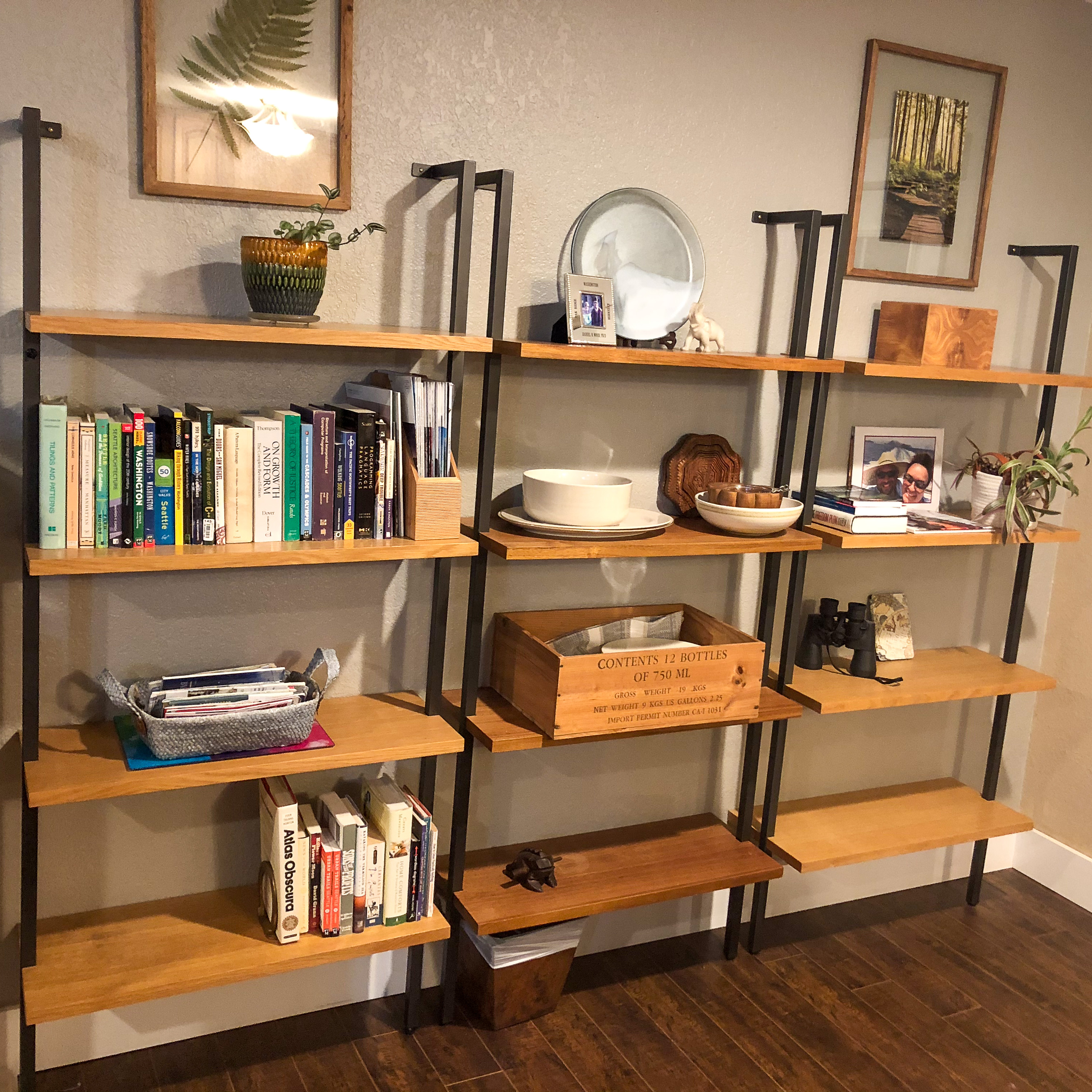 Styled open shelving with books, framed art, and decorative objects arranged neatly.