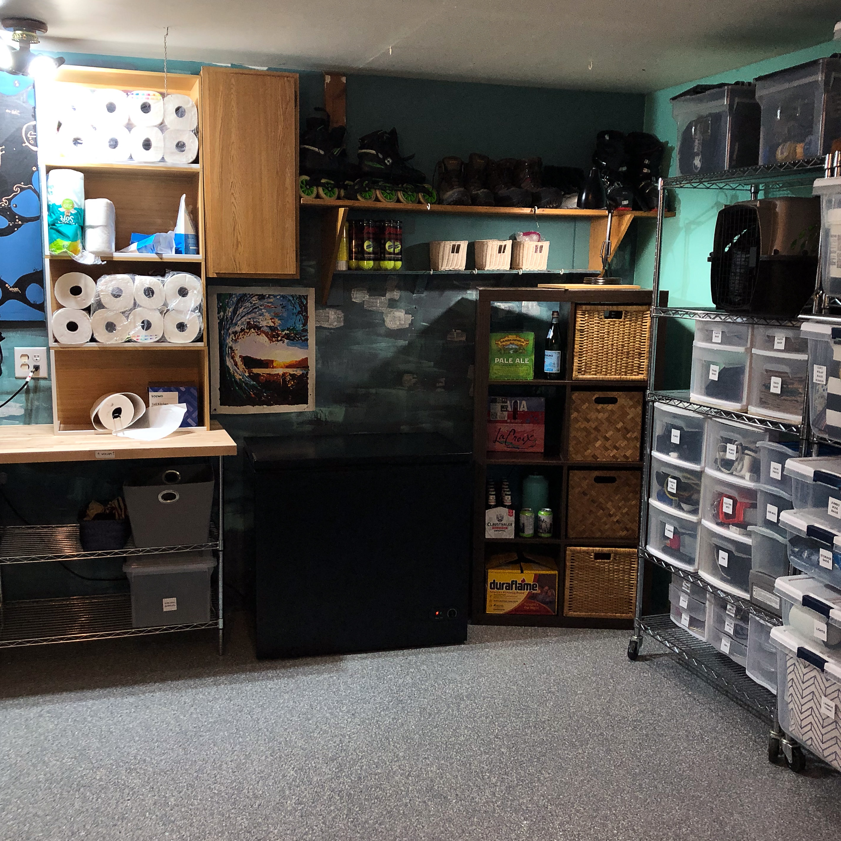 Organized storage room with labeled bins, baskets, and shelving.